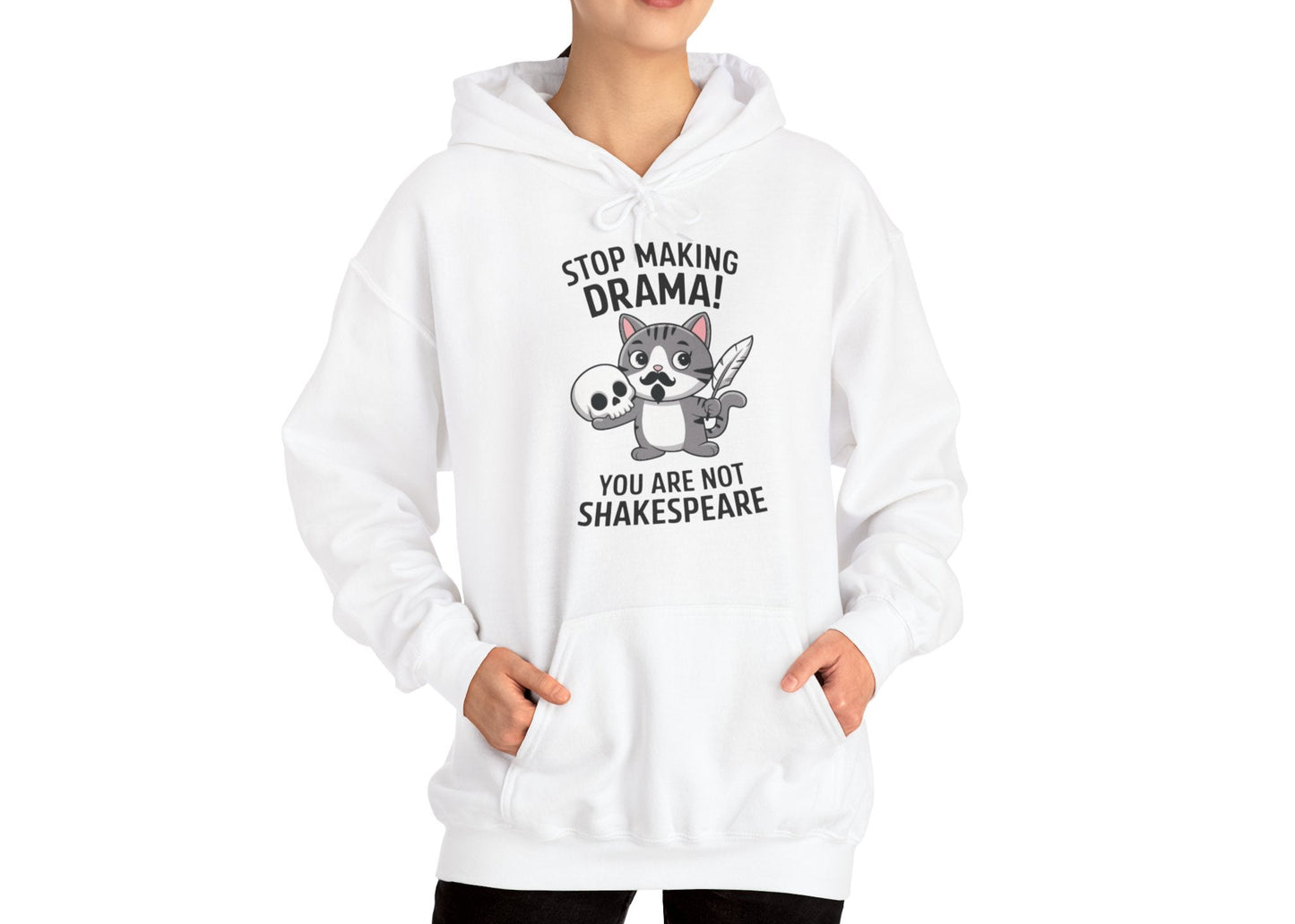 Model wearing a white hoodie with a cartoon cat holding a skull and the text "Stop Making Drama! You Are Not Shakespeare," standing with hands at sides. Part of the Vivid Divergence Sensory Friendly Unisex Hoodie Range.