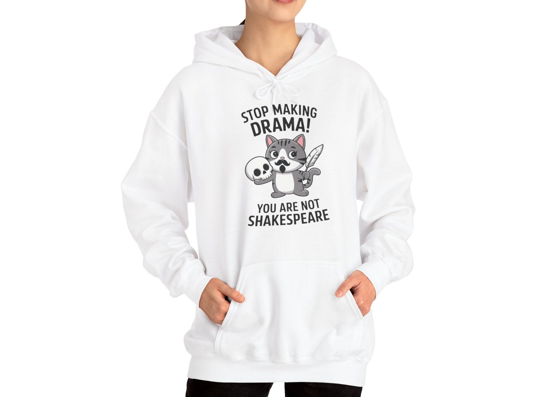 Model wearing a white hoodie with a cartoon cat holding a skull and the text "Stop Making Drama! You Are Not Shakespeare," standing with hands at sides. Part of the Vivid Divergence Sensory Friendly Unisex Hoodie Range.