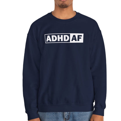 Model wearing a navy blue sweater jumper with "ADHD AF" text in bold white lettering. Part of the Vivid Divergence Sensory Friendly Unisex Sweater Jumper Range.