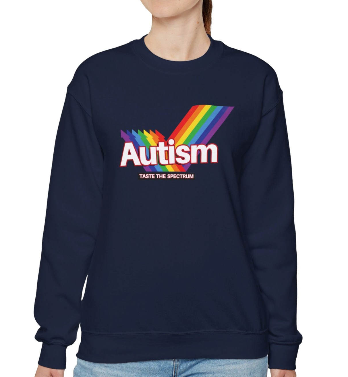 Model wearing a navy blue sweater jumper with an "Autism" Skittles brand parody design featuring rainbow stripes. Part of the Vivid Divergence Sensory Friendly Unisex Sweater Jumper Range.