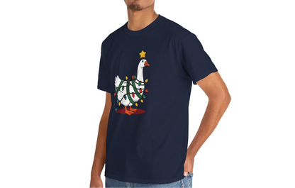Model wearing a navy blue T-shirt featuring a festive illustration of a goose wearing a Santa hat and stringing Christmas lights, with the text "Goose on the Loose." Part of the Vivid Divergence Sensory Friendly Unisex Tees Range.