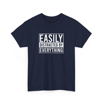 Front view of a navy blue T-shirt with the text "Easily Distracted by Everything" in bold white letters. Part of the Vivid Divergence Sensory Friendly Unisex Tees Range.