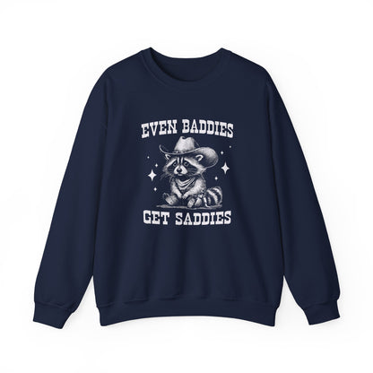 Front view of a navy blue sweater jumper with the text "Even Baddies Get Saddies" and a cartoon raccoon illustration. Part of the Vivid Divergence Sensory Friendly Unisex Sweater Jumper Range.