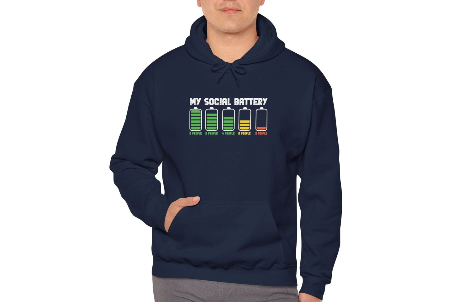 Model wearing a navy blue hoodie featuring the text "My Social Battery" with a series of battery icons decreasing from full to empty. Part of the Vivid Divergence Sensory Friendly Unisex Hoodie Range.