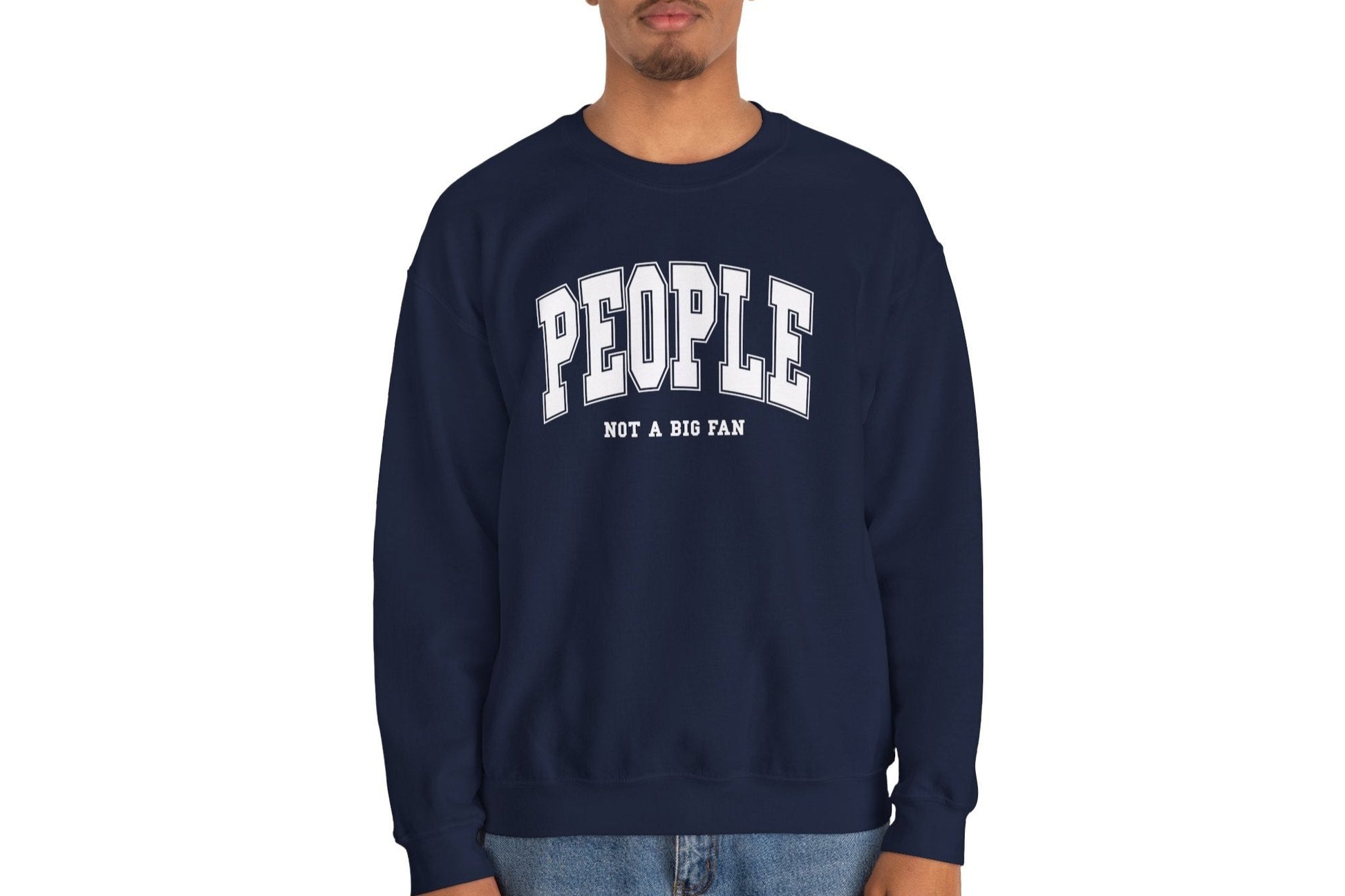 Model wearing a navy blue sweater jumper with the text "People. Not a Big Fan" in bold white lettering. Part of the Vivid Divergence Sensory Friendly Unisex Sweater Jumper Range.