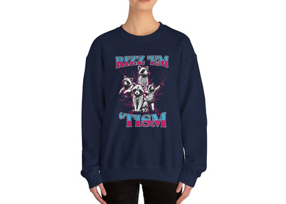 Model wearing a navy blue sweater jumper with the text "Rizz 'Em 'Tism" and a cartoon raccoon illustration striking a pose. Part of the Vivid Divergence Sensory Friendly Unisex Sweater Jumper Range.