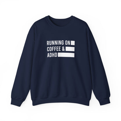 Front view of a navy blue sweater jumper with the text "Running on Coffee & ADHD" in bold white lettering and a battery graphic. Part of the Vivid Divergence Sensory Friendly Unisex Sweater Jumper Range.