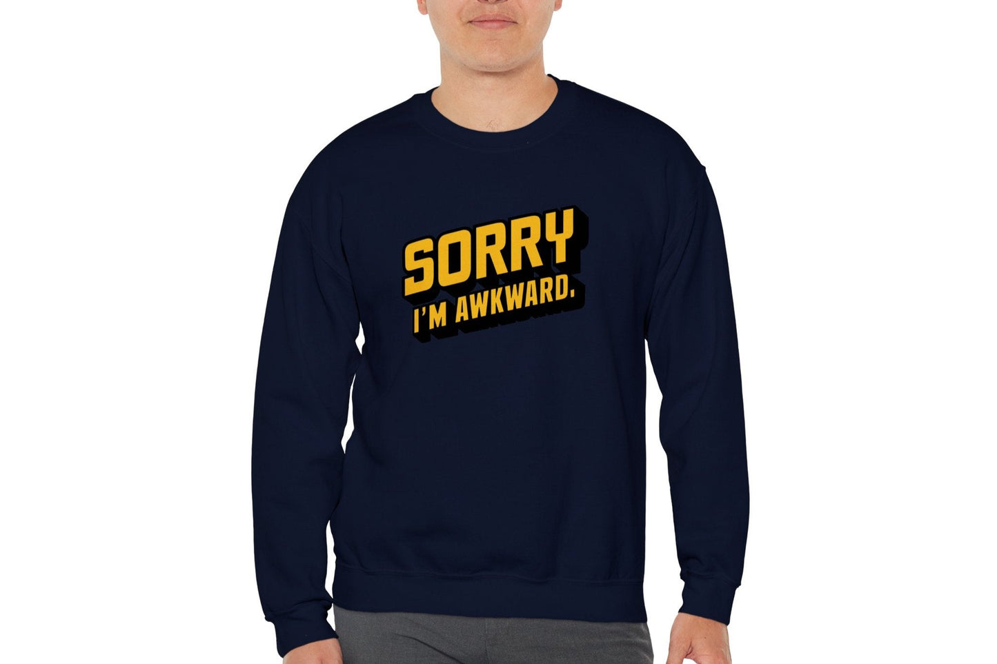 Model wearing a navy blue sweater jumper with the text "Sorry, I'm Awkward." in bold yellow lettering. Part of the Vivid Divergence Sensory Friendly Unisex Sweater Jumper Range.