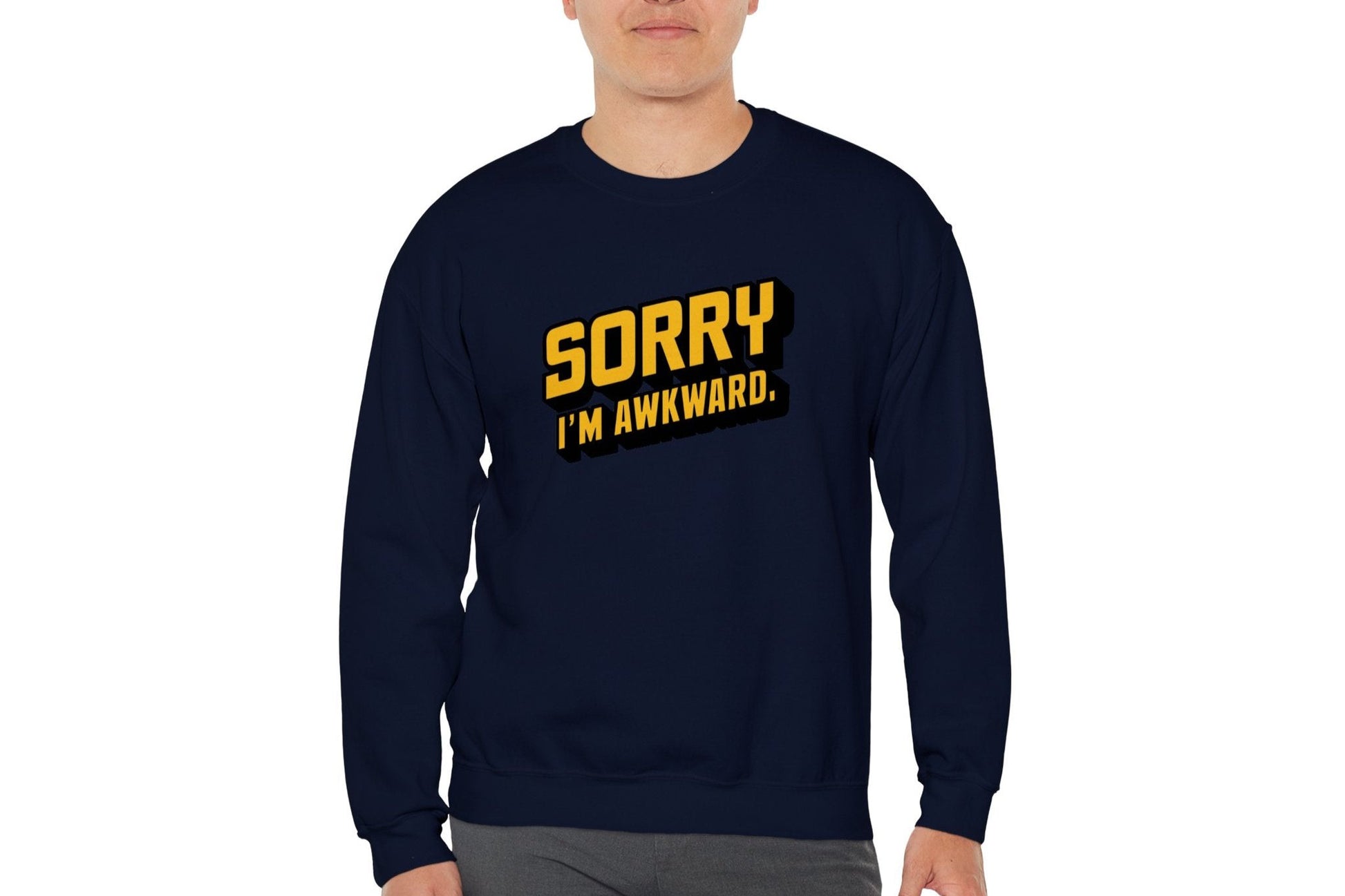 Model wearing a navy blue sweater jumper with the text "Sorry, I'm Awkward." in bold yellow lettering. Part of the Vivid Divergence Sensory Friendly Unisex Sweater Jumper Range.