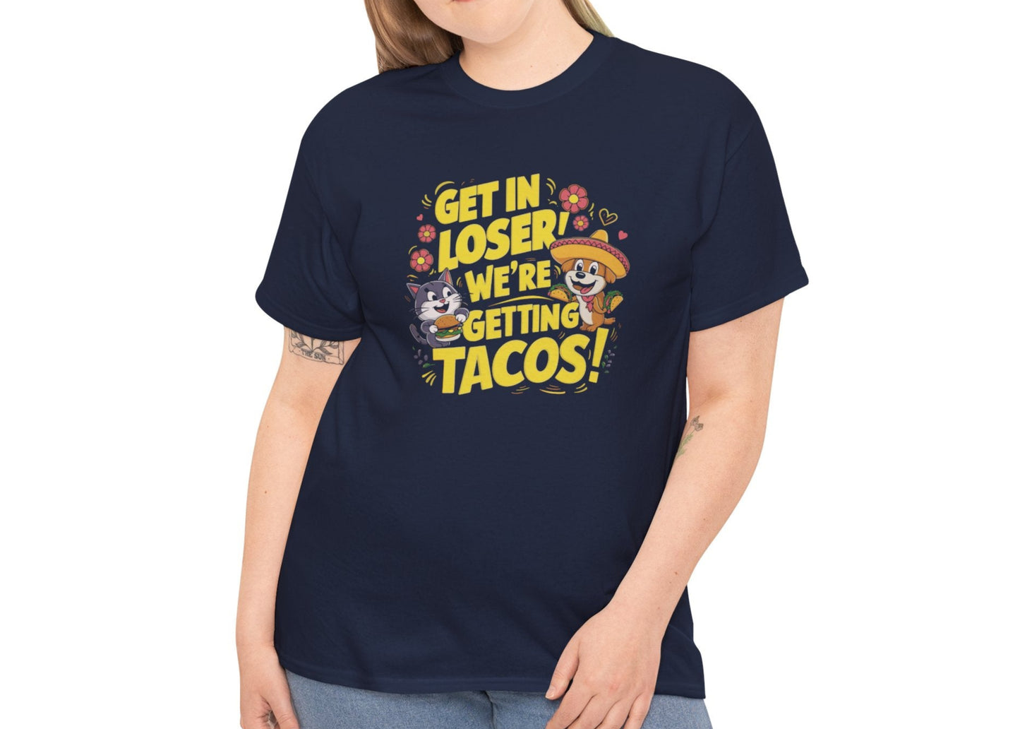 Modeled front view of a navy blue T-shirt with colorful text and illustrations of cute animals in a car that reads "Get In Loser, We're Getting Tacos!" Part of the Vivid Divergence Sensory Friendly Unisex Tees Range.