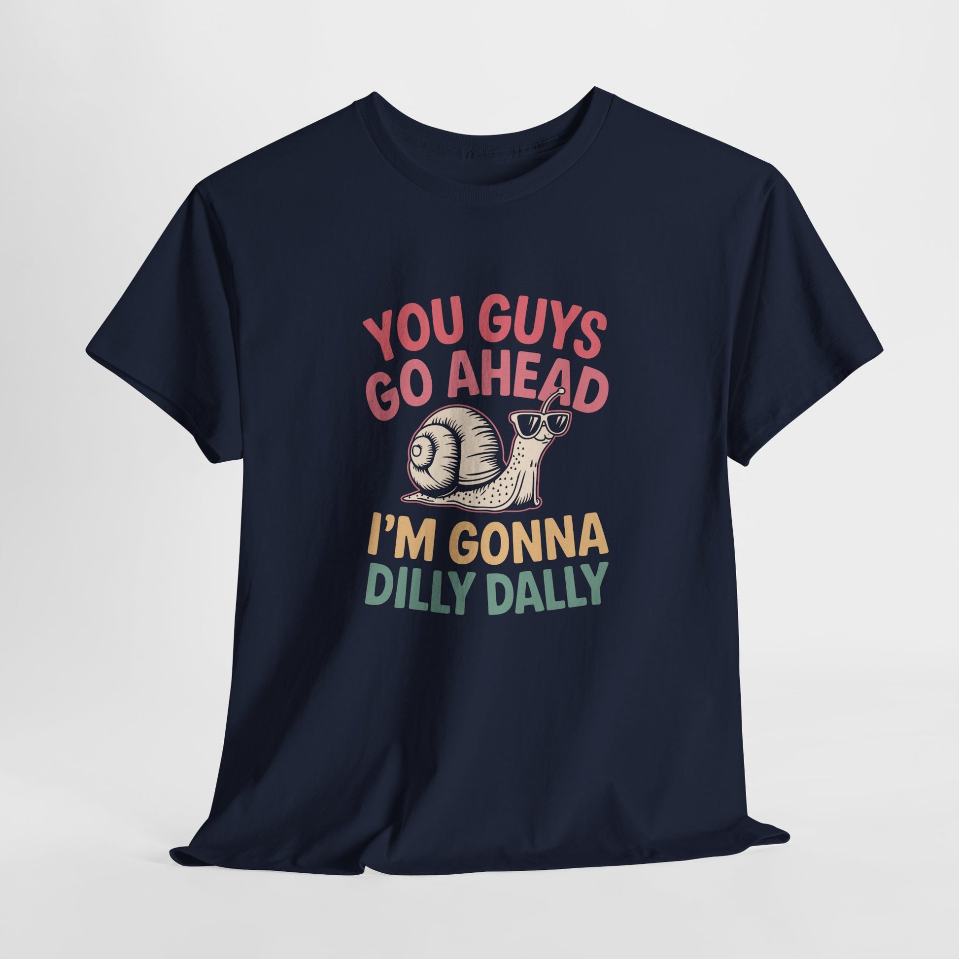 Hanging navy blue T-shirt featuring "You Guys Go Ahead, I'm Gonna Dilly Dally" text in a retro 90s-style font with a snail illustration. Part of the Vivid Divergence Sensory Friendly Unisex Tees Range.