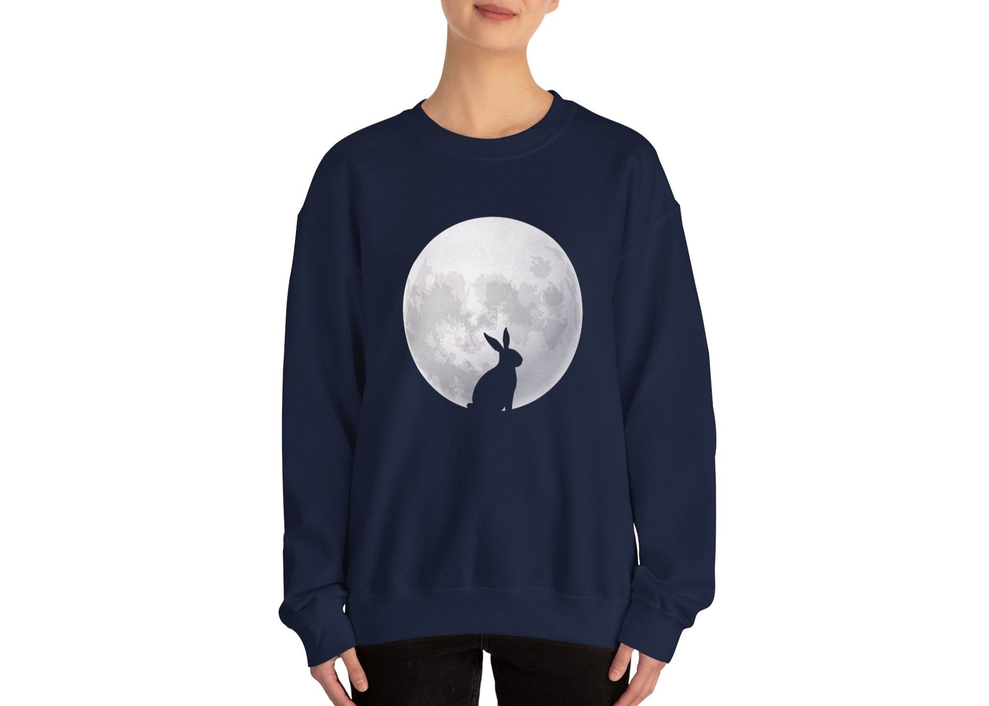 Woman in navy sweater jumper with minimalist Easter bunny and full moon print. Part of the Vivid Divergence Sensory Friendly Unisex Sweater Jumper Range.
