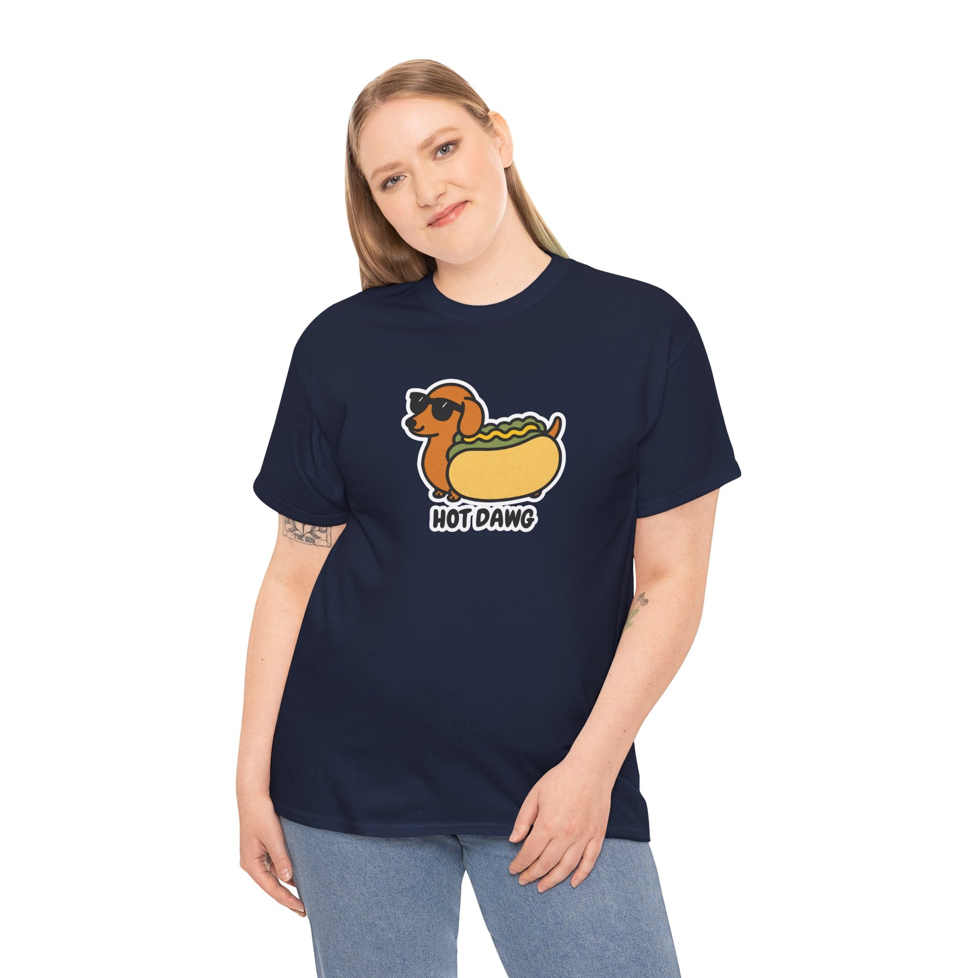 Model wearing a navy T-shirt featuring a "Hot Dawg" design with a cartoon dachshund inside a hot dog bun wearing sunglasses. Part of the Vivid Divergence Sensory Friendly Unisex Tees Range.