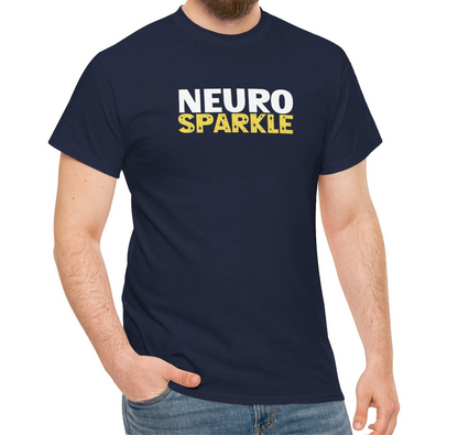 Model wearing a navy T-shirt with "Neurosparkle" in bold white and yellow text. Part of the Vivid Divergence Sensory Friendly Unisex Tees Range.