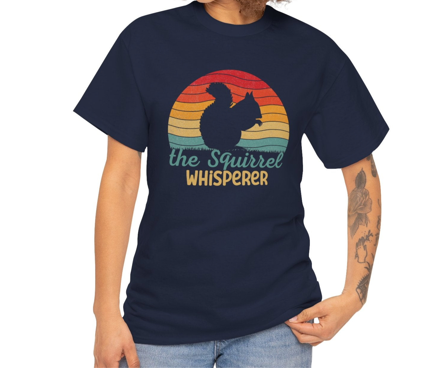Model wearing a navy T-shirt with "The Squirrel Whisperer" and a silhouette of a squirrel against a retro sunset design. Part of the Vivid Divergence Sensory Friendly Unisex Tees Range.