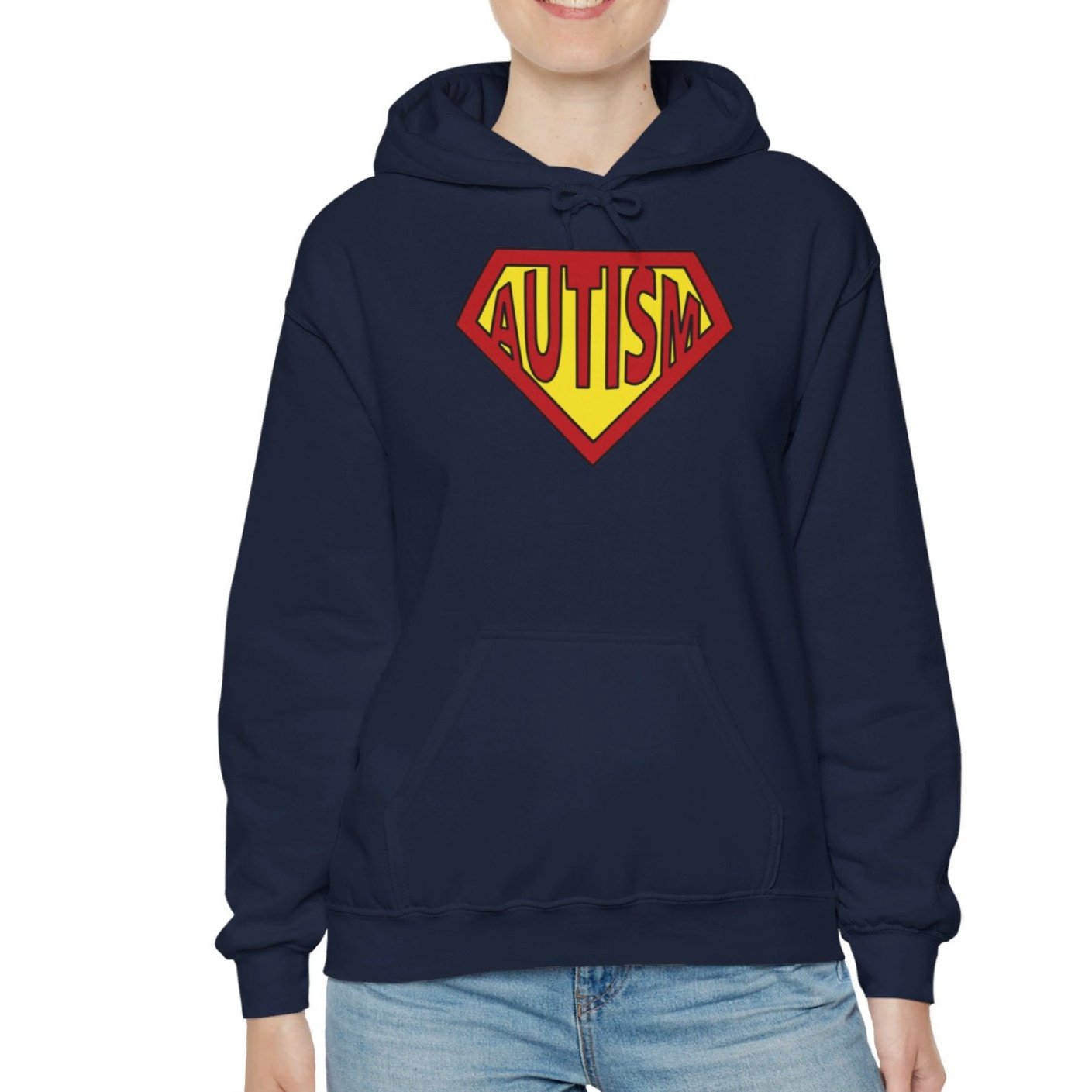 Model wearing a navy blue hoodie featuring the text "Autism" inside a Superman-style red and yellow shield design. Part of the Vivid Divergence Sensory Friendly Unisex Hoodie Range.