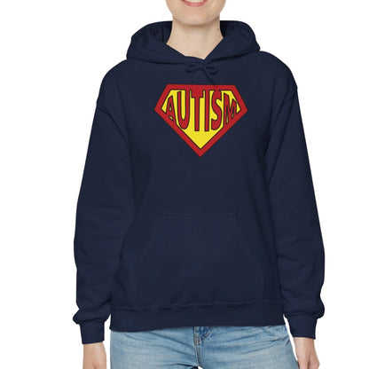Model wearing a navy blue hoodie featuring the text "Autism" inside a Superman-style red and yellow shield design. Part of the Vivid Divergence Sensory Friendly Unisex Hoodie Range.