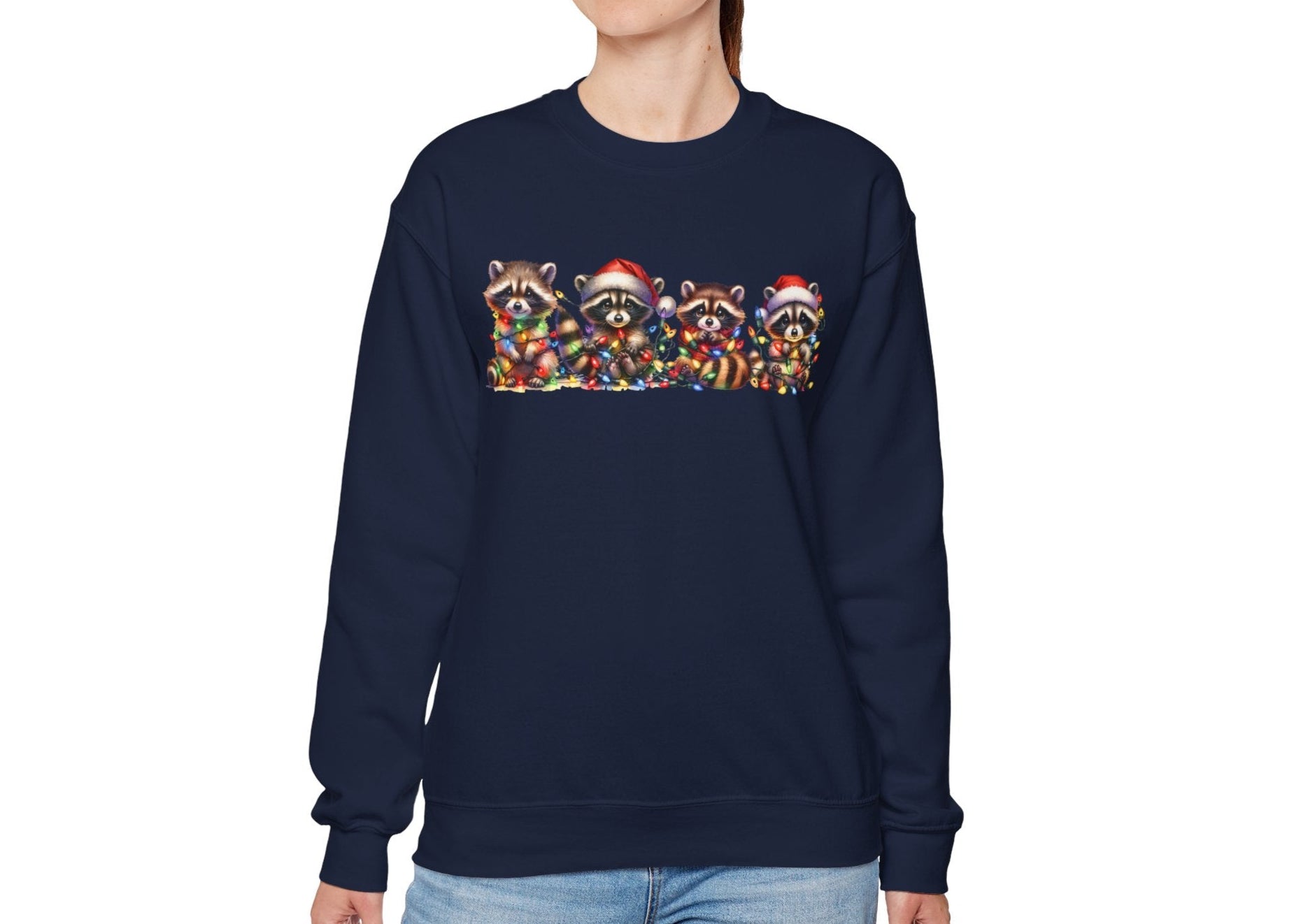 Model wearing a navy blue sweatshirt featuring a festive illustration of raccoons in Christmas attire causing holiday chaos. Part of the Vivid Divergence Sensory Friendly Unisex Sweater Jumper Range.