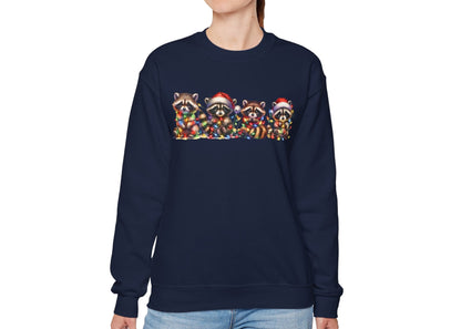 Model wearing a navy blue sweatshirt featuring a festive illustration of raccoons in Christmas attire causing holiday chaos. Part of the Vivid Divergence Sensory Friendly Unisex Sweater Jumper Range.