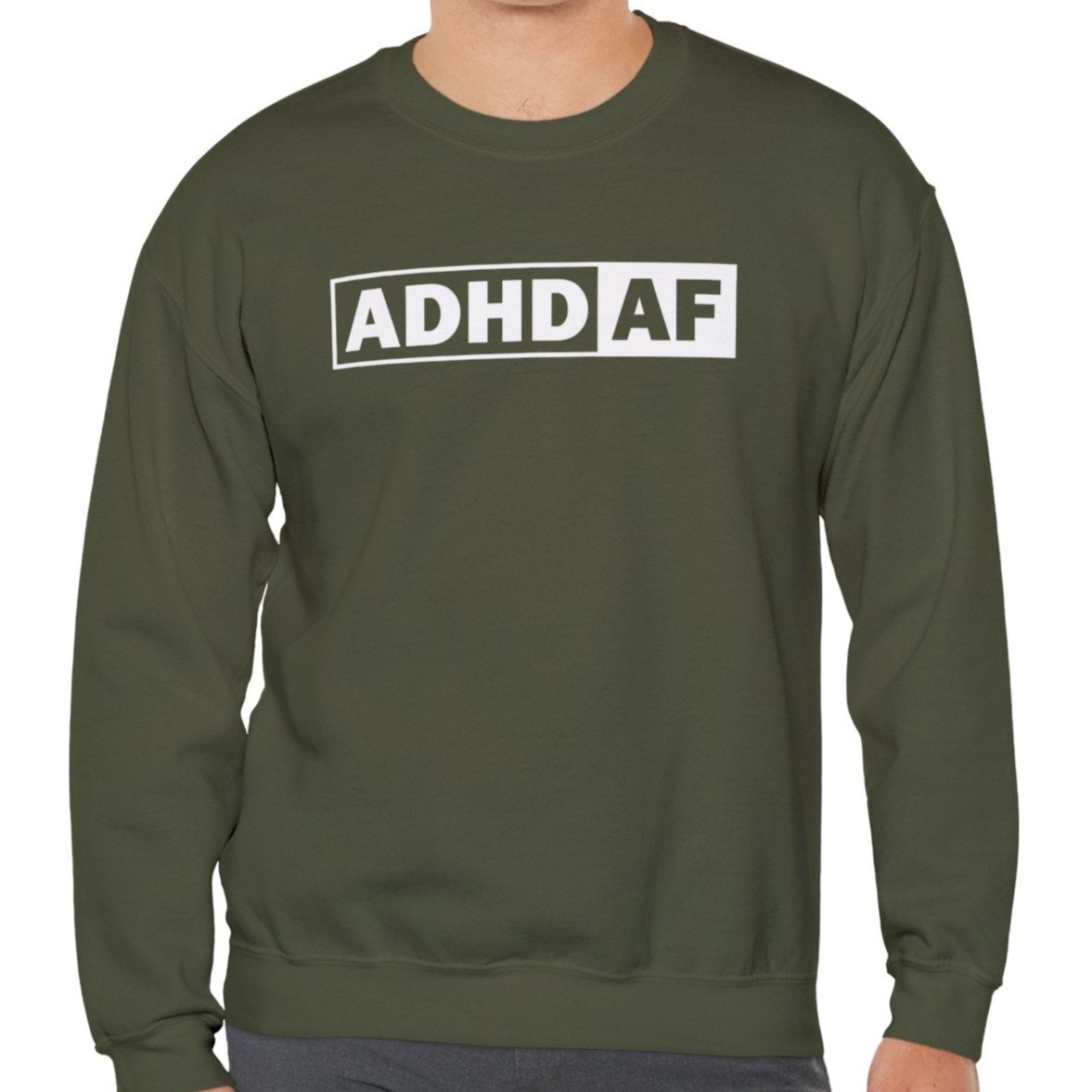 Model wearing an olive green sweater jumper with "ADHD AF" text in bold white lettering. Part of the Vivid Divergence Sensory Friendly Unisex Sweater Jumper Range.