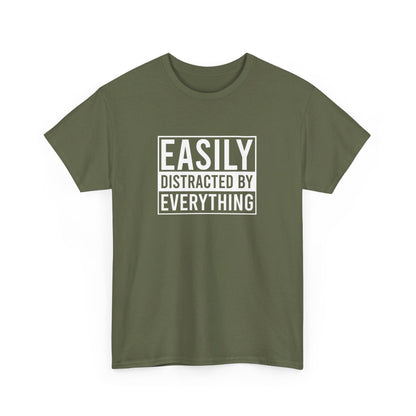 Front view of an olive green T-shirt with the text "Easily Distracted by Everything" in bold white letters. Part of the Vivid Divergence Sensory Friendly Unisex Tees Range.