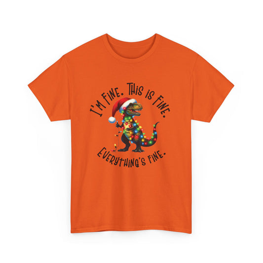Front view of an orange T-shirt featuring a festive illustration of a dinosaur tangled in Christmas lights with the text "I’m Fine. This is Fine. Everything is Fine." Part of the Vivid Divergence Sensory Friendly Unisex Tees Range.
