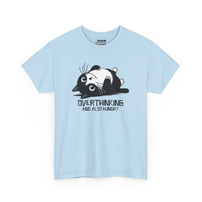 Front view of light blue T-shirt featuring black line art of a wide-eyed cat surrounded by scribbles, with the phrase "Overthinking and also hungry." A whole vibe. Part of the Vivid Divergence Memewear Collection!