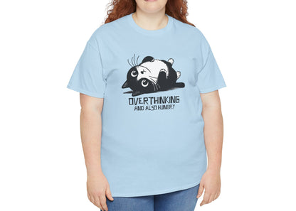 Modeled view of light blue T-shirt featuring black line art of a wide-eyed cat surrounded by scribbles, with the phrase "Overthinking and also hungry." A whole vibe. Part of the Vivid Divergence Memewear Collection!