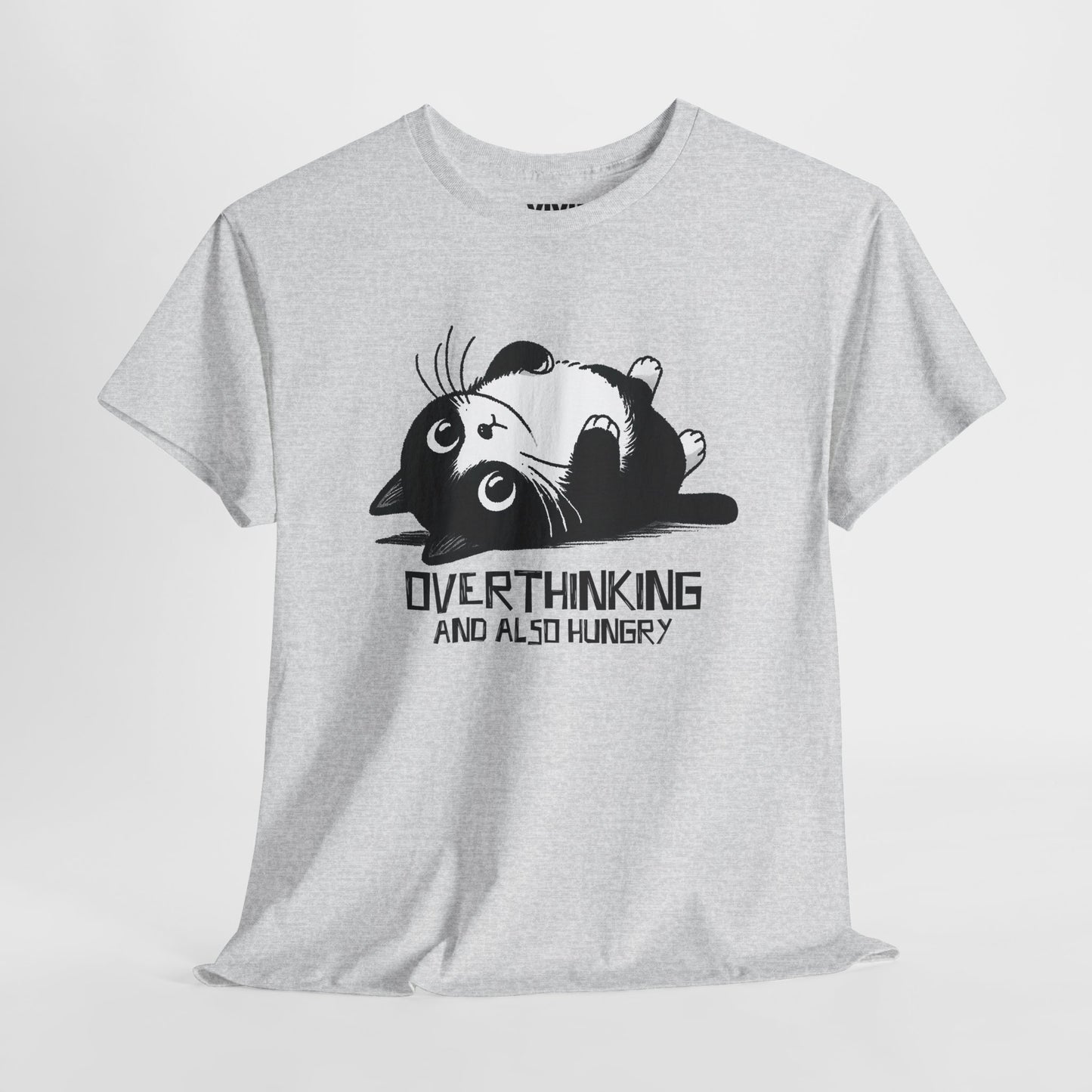 Hanging view of light grey T-shirt featuring black line art of a wide-eyed cat surrounded by scribbles, with the phrase "Overthinking and also hungry." A whole vibe. Part of the Vivid Divergence Memewear Collection!