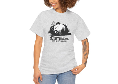 Modeled view of light grey T-shirt featuring black line art of a wide-eyed cat surrounded by scribbles, with the phrase "Overthinking and also hungry." A whole vibe. Part of the Vivid Divergence Memewear Collection!
