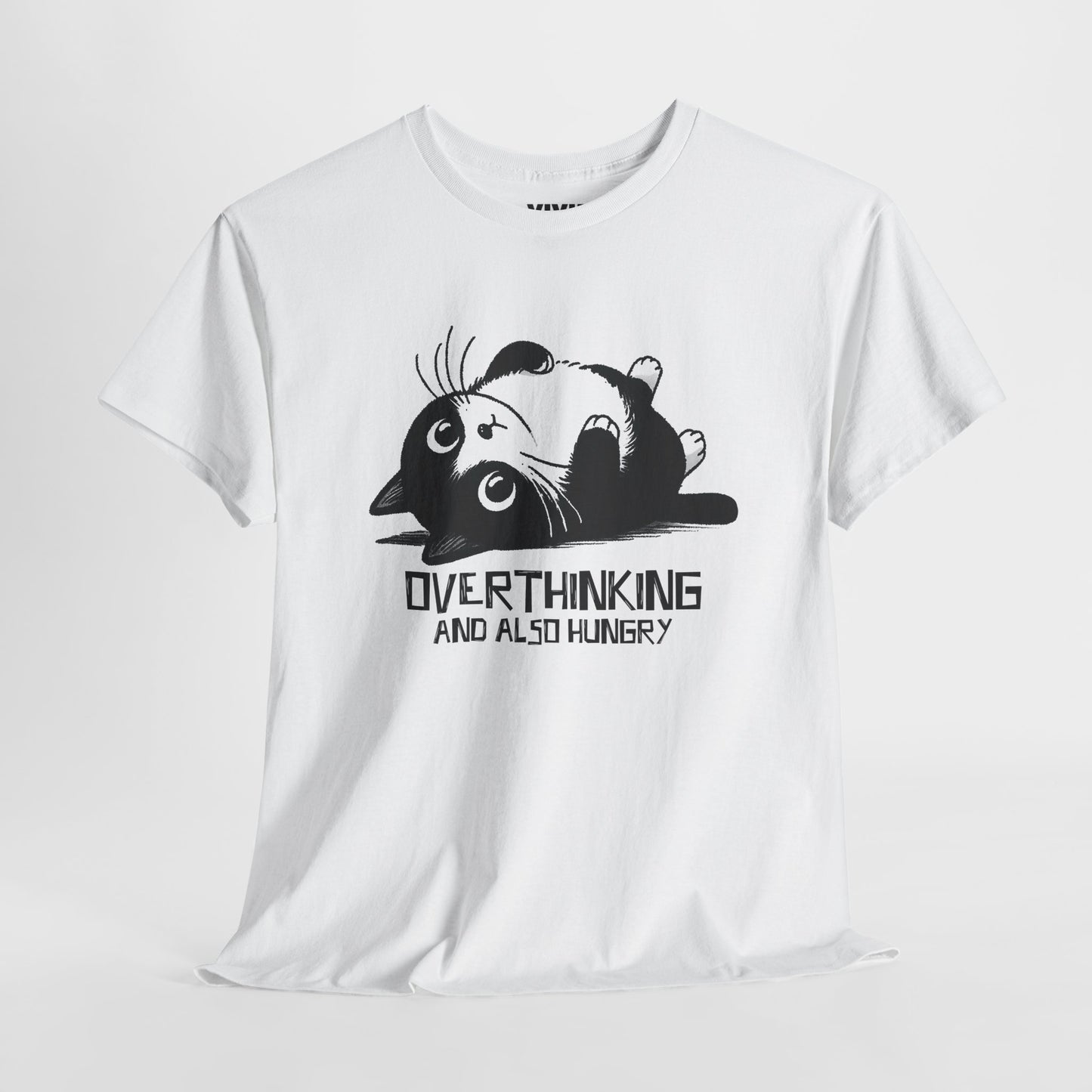 Hanging view of white T-shirt featuring black line art of a wide-eyed cat surrounded by scribbles, with the phrase "Overthinking and also hungry." A whole vibe. Part of the Vivid Divergence Memewear Collection!
