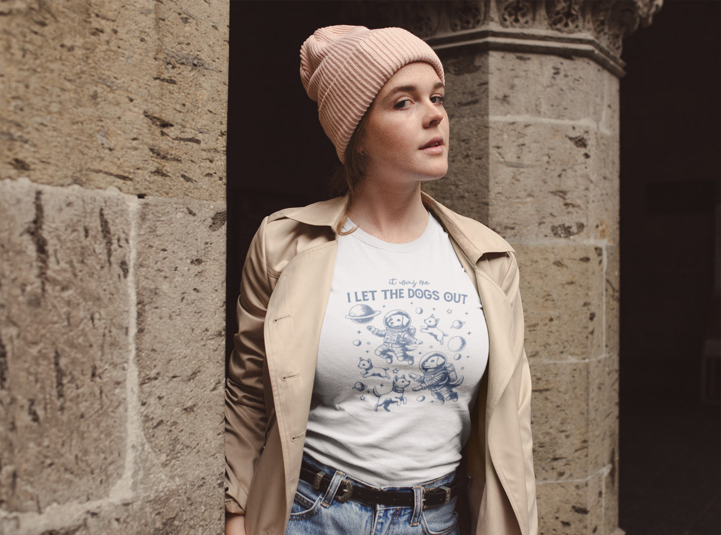 A person wearing a white T-shirt featuring astronaut dogs in space suits with playful text, styled in an outdoor setting. Part of the Vivid Divergence Sensory Friendly Unisex Tees Range.