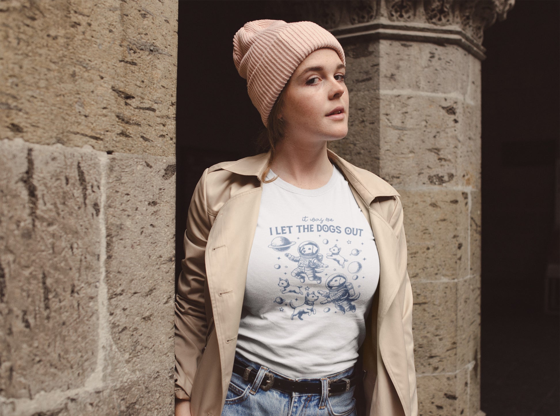  A person wearing a white T-shirt featuring astronaut dogs in space suits with playful text, styled in an outdoor setting. Part of the Vivid Divergence Sensory Friendly Unisex Tees Range.