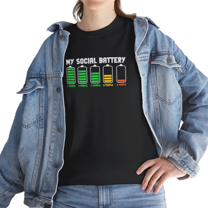 A person wearing a black T-shirt with a battery icon graphic displaying varying levels and the text "My Social Battery," styled with a denim jacket. Part of the Vivid Divergence Sensory Friendly Unisex Tees Range.
