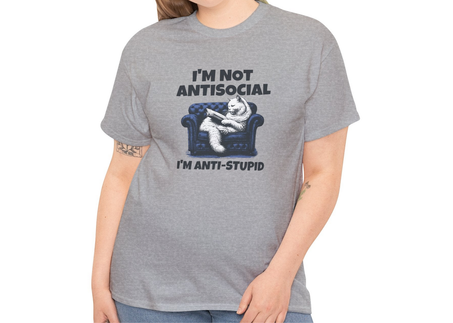 A person wearing a gray T-shirt with a graphic of a cat on a couch and the text "I'm Not Anti-Social, I'm Anti-Stupid." Part of the Vivid Divergence Sensory Friendly Unisex Tees Range.