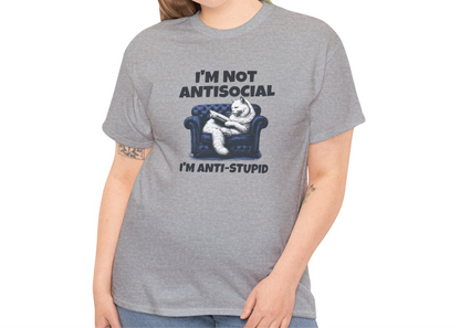 A person wearing a gray T-shirt with a graphic of a cat on a couch and the text "I'm Not Anti-Social, I'm Anti-Stupid." Part of the Vivid Divergence Sensory Friendly Unisex Tees Range.