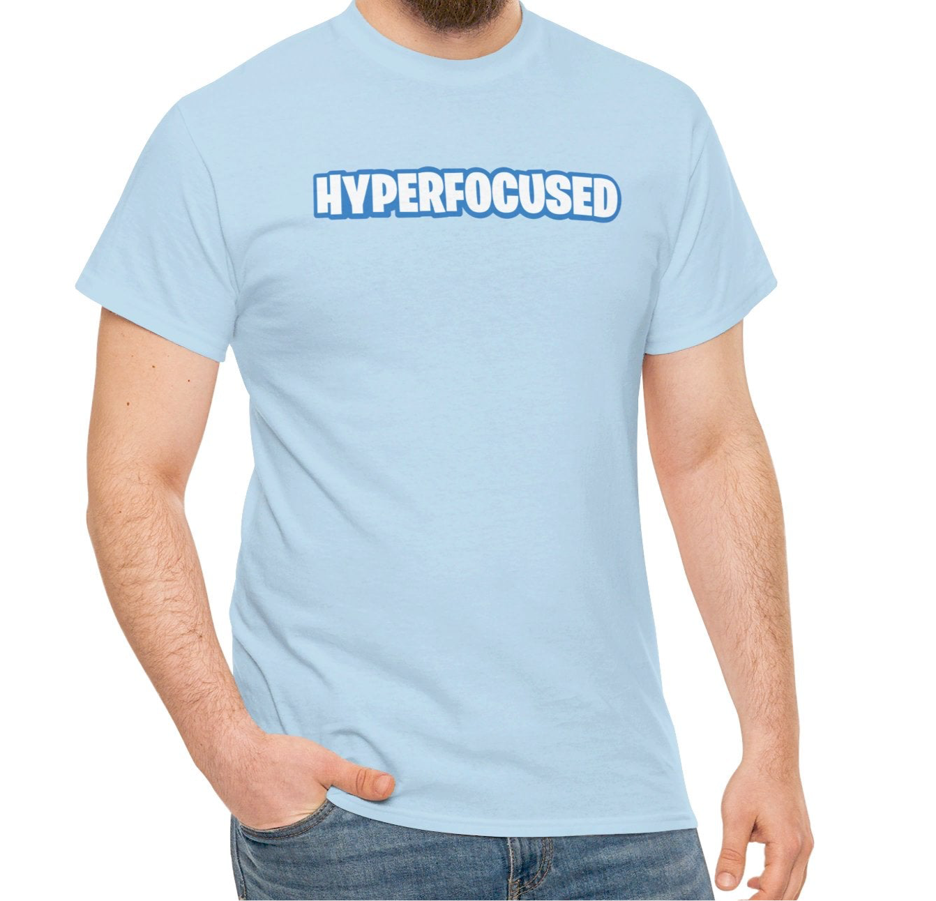 A person wearing a light blue T-shirt with the text "Hyperfocused" in a Fortnite-style design. Part of the Vivid Divergence Sensory Friendly Unisex Tees Range.