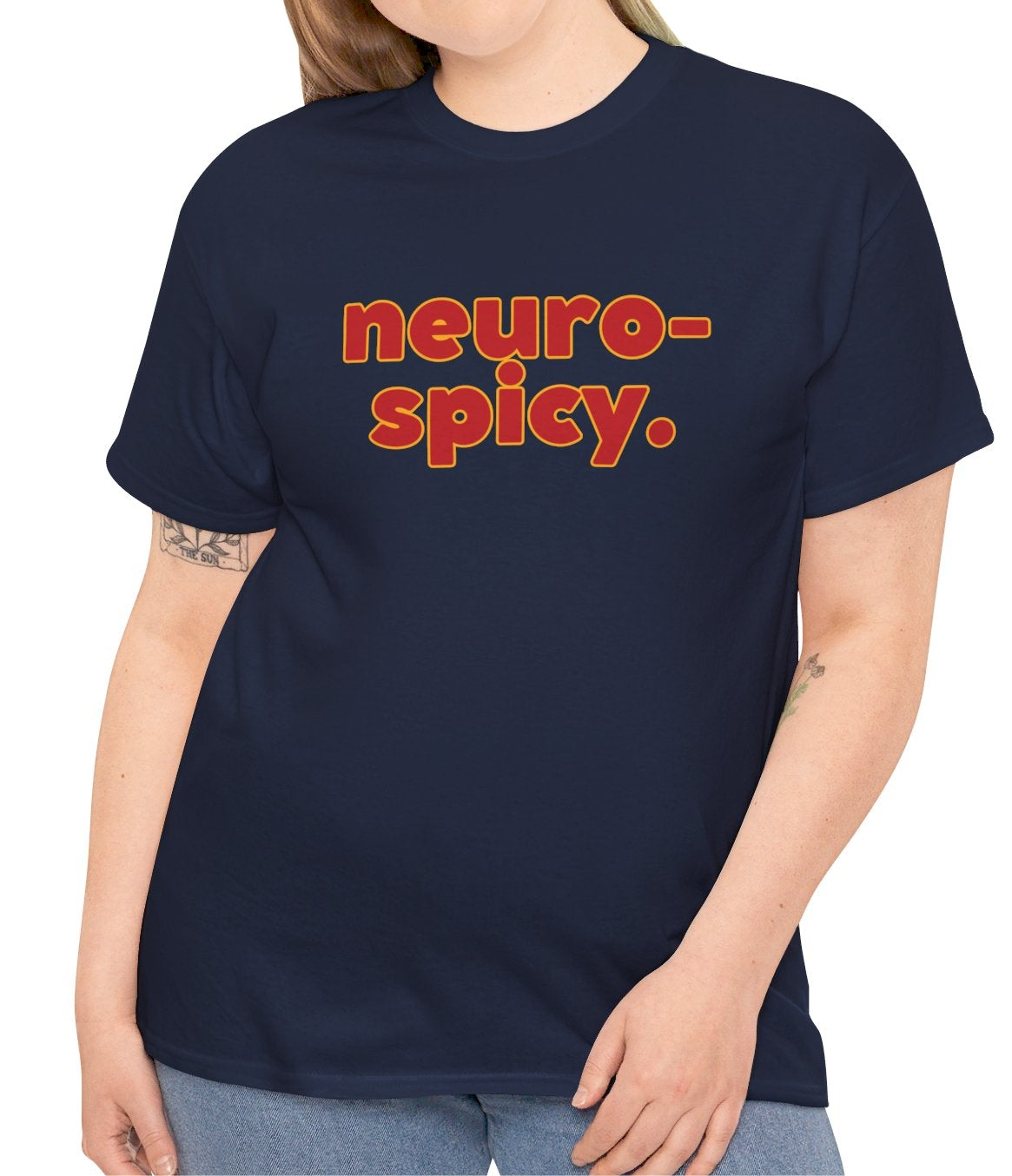 A person wearing a navy T-shirt with the text "Neuro-Spicy" in retro-style lettering. Part of the Vivid Divergence Sensory Friendly Unisex Tees Range.