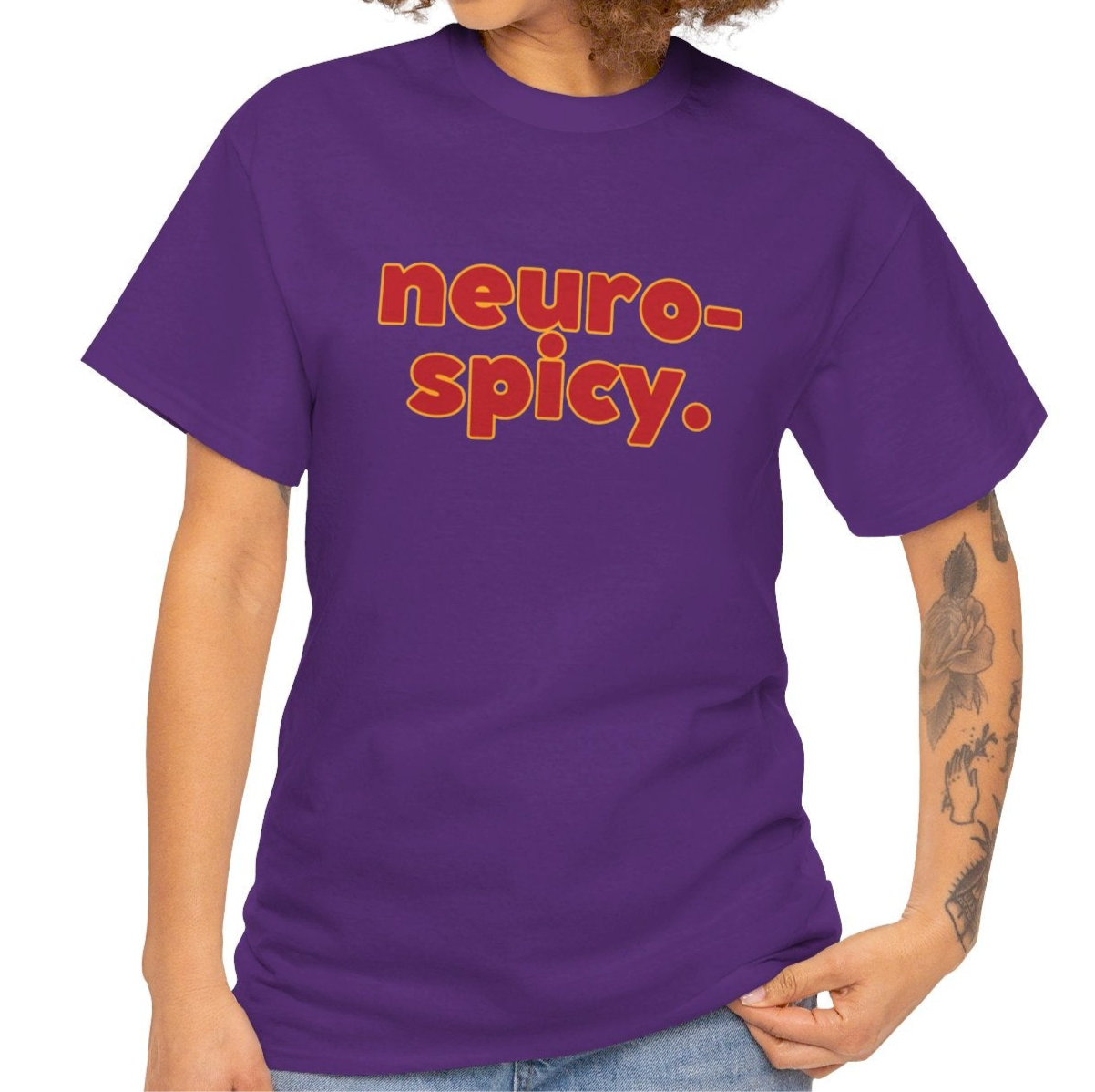 A person wearing a purple T-shirt with the text "Neuro-Spicy" in retro-style lettering. Part of the Vivid Divergence Sensory Friendly Unisex Tees Range.
