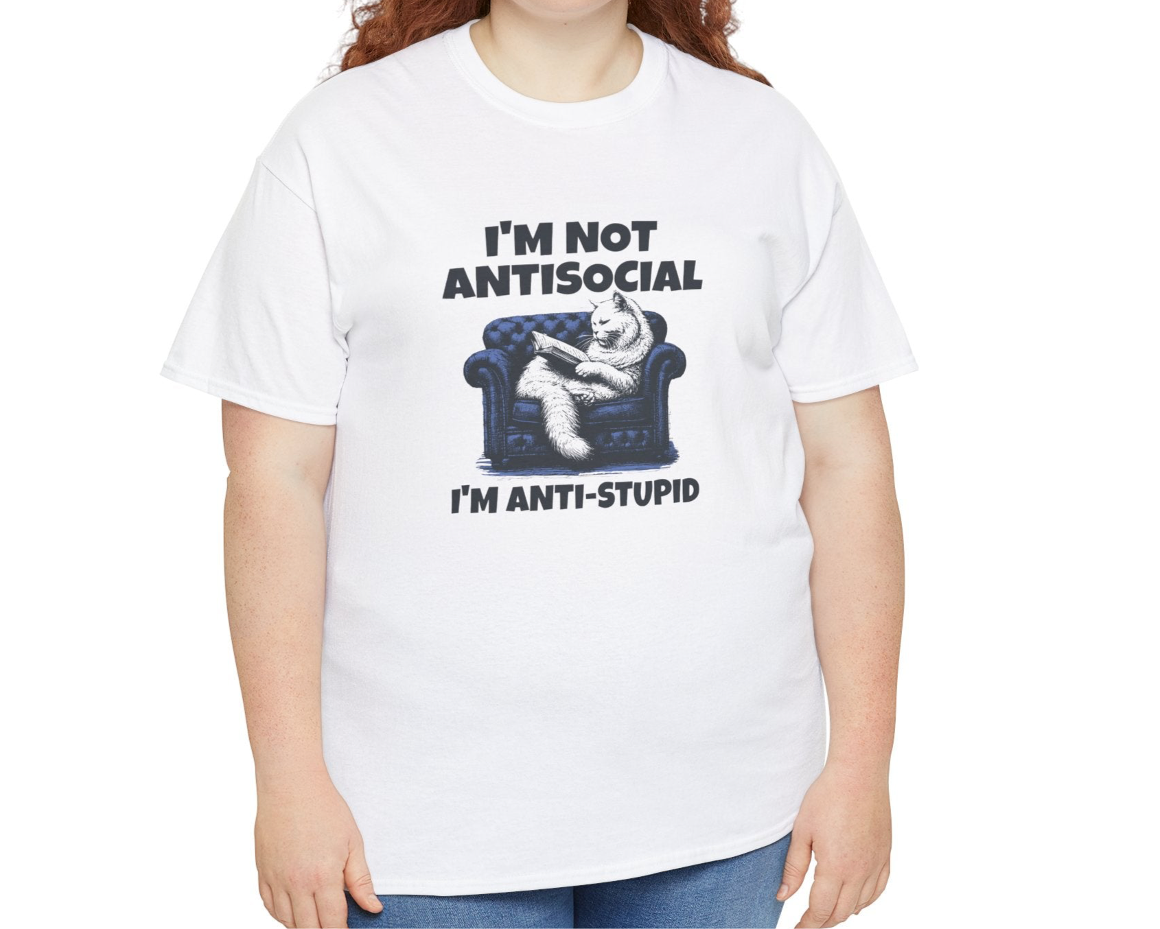 A person wearing a white T-shirt with a graphic of a cat on a couch and the text "I'm Not Anti-Social, I'm Anti-Stupid." Part of the Vivid Divergence Sensory Friendly Unisex Tees Range.