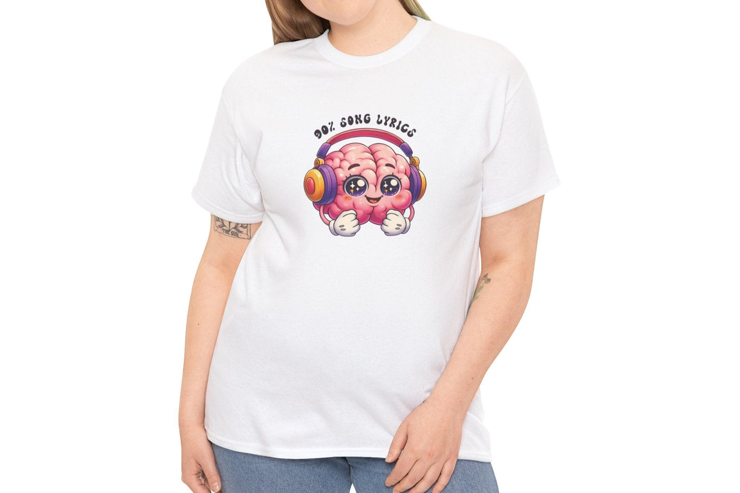 A person wearing a white T-shirt with a colorful brain graphic, headphones, and the text "My Brain is 90% Song Lyrics." Part of the Vivid Divergence Sensory Friendly Unisex Tees Range.