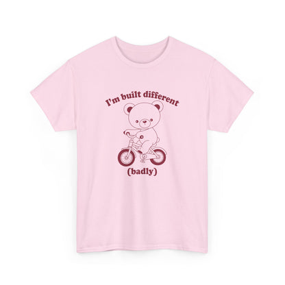 Front view of a pink T-shirt featuring the "Built Different (Badly)" bear design. Part of the Vivid Divergence Sensory Friendly Unisex Tees Range.