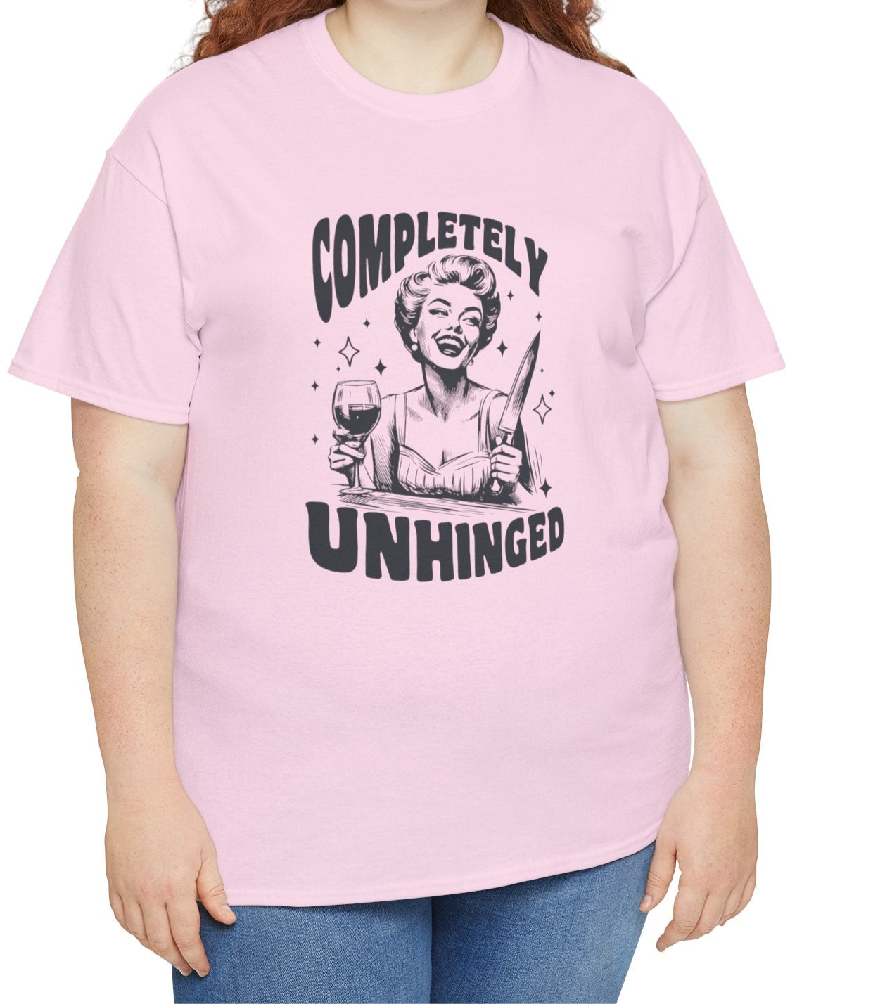 Model wearing a pink T-shirt with "Completely Unhinged" text and graphic design. Part of the Vivid Divergence Sensory Friendly Unisex Tees Range.