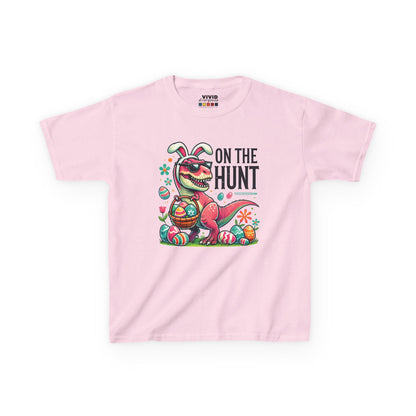 Pink kids' T-shirt with a cheerful Easter dinosaur, "On the Hunt" text, and colorful eggs. A festive choice for Easter fun. Hop into the season in style and shop Easter shirts online today!