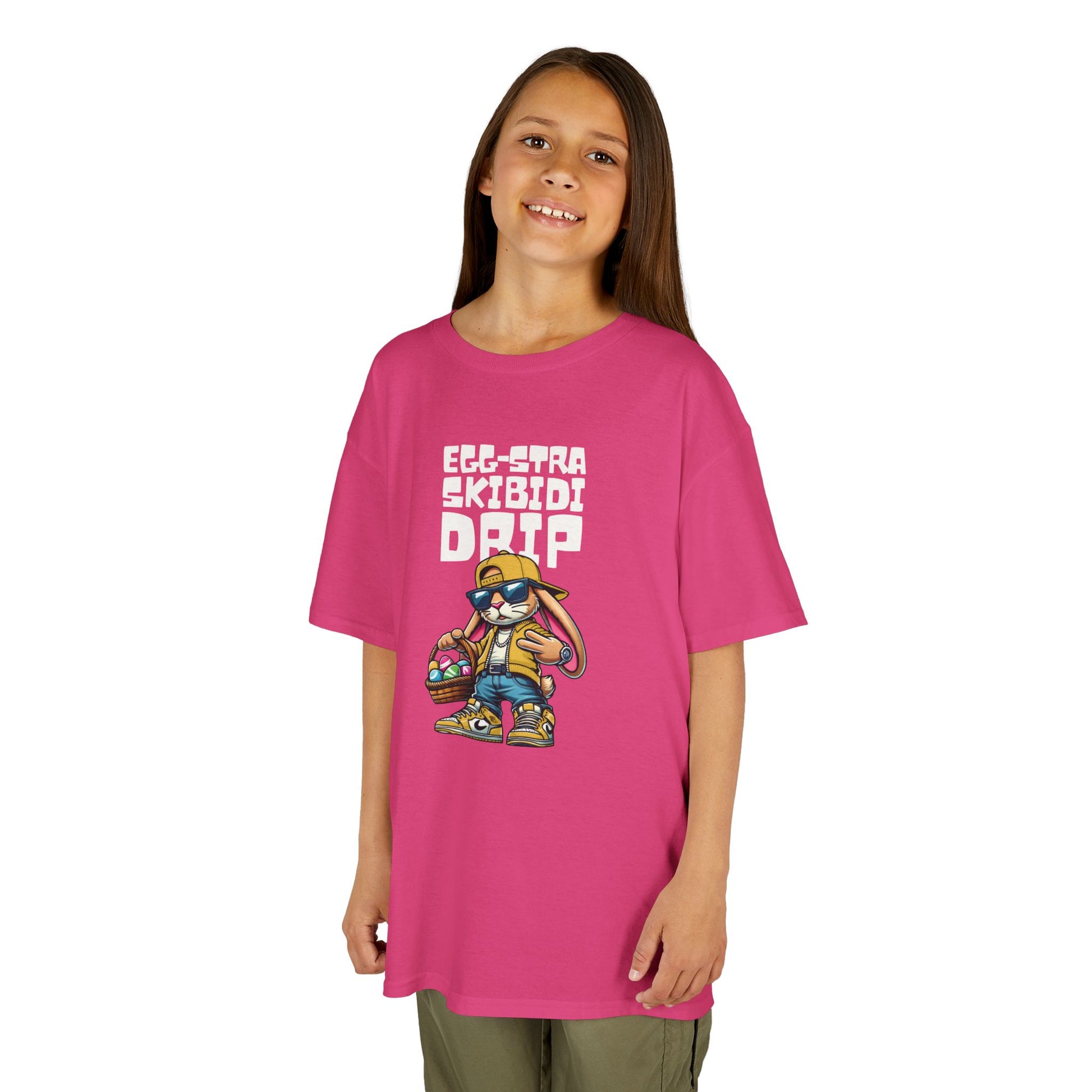 Child wearing a pink Easter T-shirt featuring a Skibidi bunny with "Egg-Stra Skibidi Drip" text, a playful and fun outfit choice. Hop into the season in style and shop Easter shirts online today!