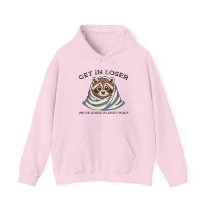 Front view of a pink hoodie featuring a raccoon wrapped in a blanket with the text "Get in Loser, We're Going Blanky Mode." Part of the Vivid Divergence Sensory Friendly Unisex Hoodie Range.
