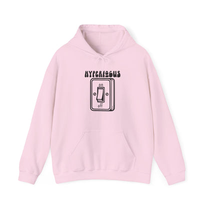 Front view of a pink hoodie featuring the text "Hyperfocus" and an illustration of a toggle switch turned on. Part of the Vivid Divergence Sensory Friendly Unisex Hoodie Range.