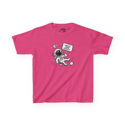 Front view of a pink "I Need More Space" astronaut kids T-shirt featuring a cartoon astronaut floating among space icons. Part of the Vivid Divergence Sensory Friendly Kids Shirts Range. The perfect T-shirt for sensory-sensitive kids and comes with a Sensory Satisfaction Promise.
