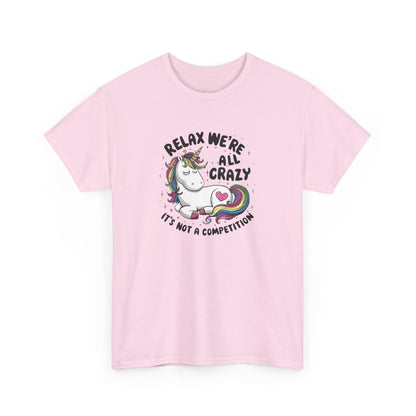 Front view of a pink T-shirt with "Relax, We're All Crazy" and a whimsical cat graphic in black text. Part of the Vivid Divergence Sensory Friendly Unisex Tees Range.