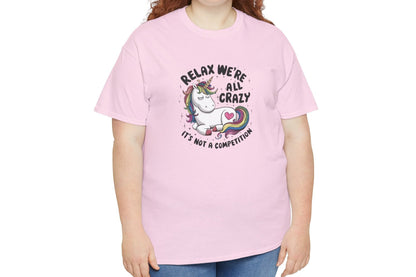 Model wearing a pink T-shirt with "Relax, We're All Crazy" and a whimsical cat graphic in black text. Part of the Vivid Divergence Sensory Friendly Unisex Tees Range.